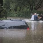 : Volunteers and officers from the neiborhood security patrol help to rescue residents in the upscale River Oaks neighborhood after it was inundated with flooding from Hurricane Harvey on August 27, 2017 in Houston, Texas.<br>